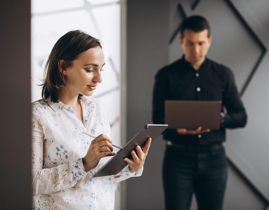 Business woman and bussiness man colleagues working on laptop