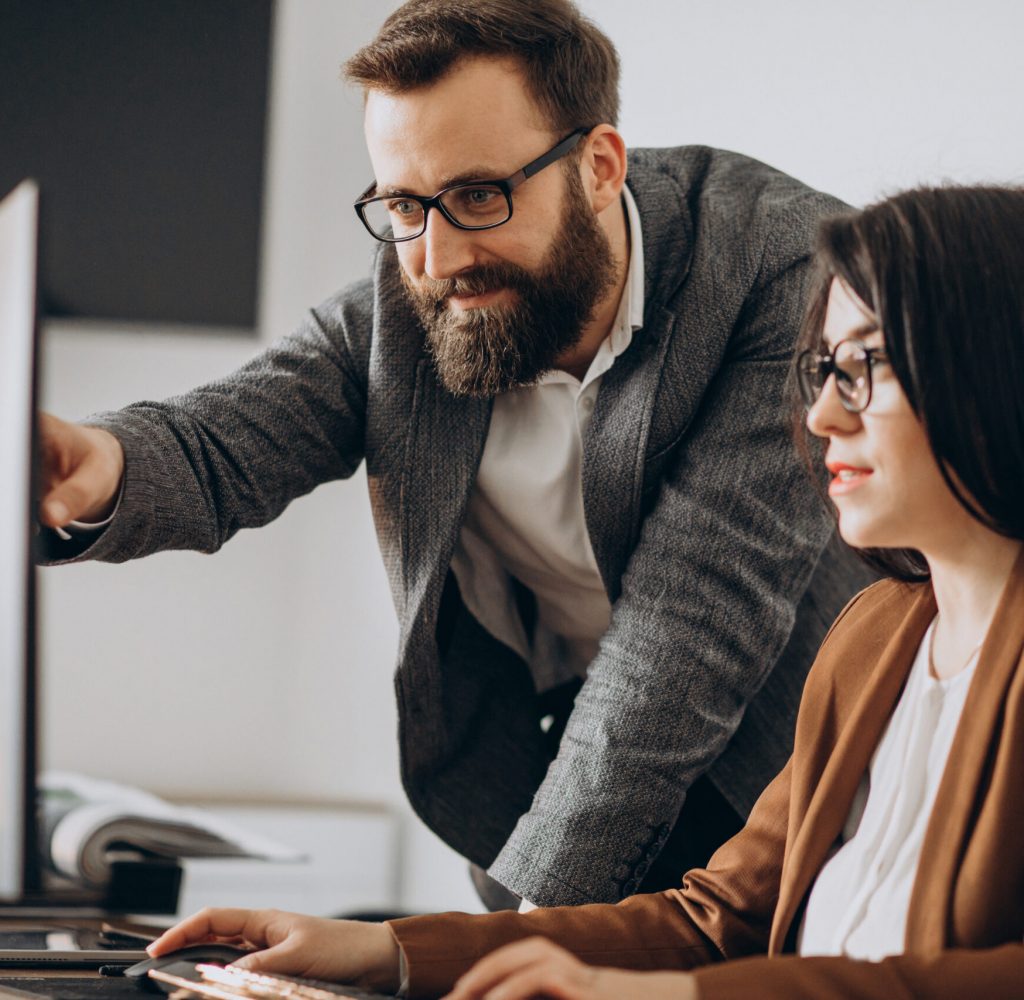 Two business partners working together in office on computer