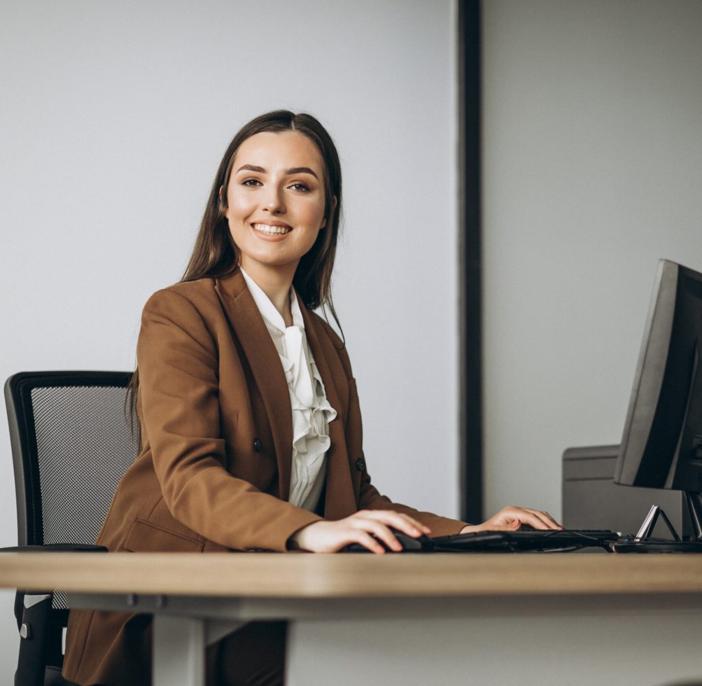 Young business woman working on laptop in office